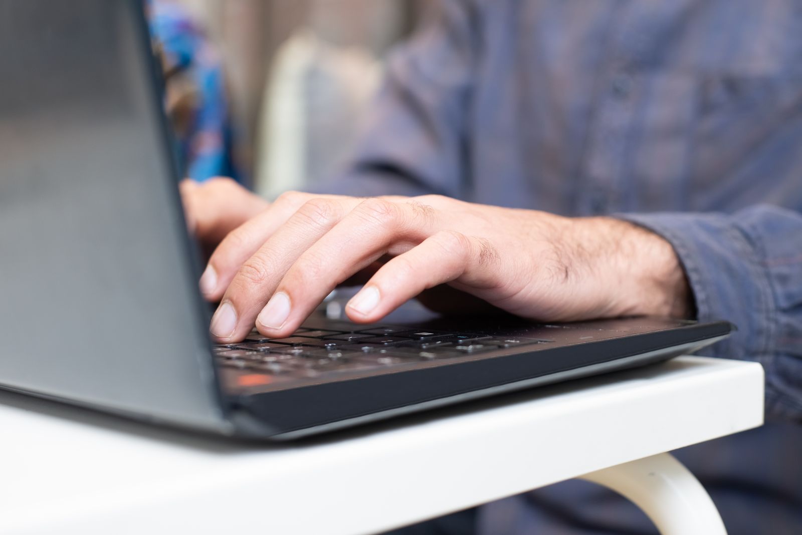 Case handler reviewing a file on a laptop